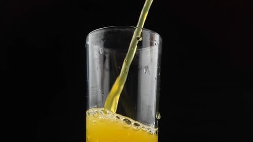 Refreshing Golden Liquid Pours Into a Glass