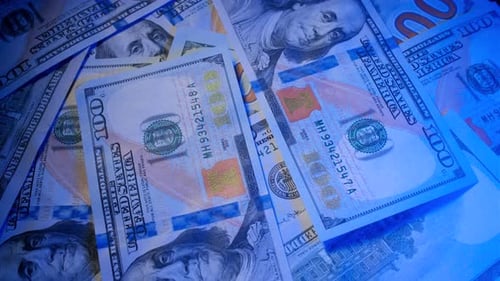 American 100 Dollar Banknotes Are Rotating on the Table Close Up