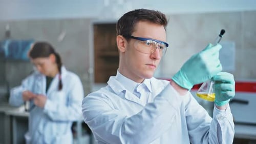 Scientist Analyzing Liquid Sample in a Laboratory