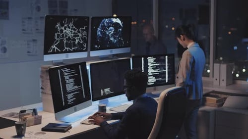 Nighttime Cybersecurity Team Working at Urban Office