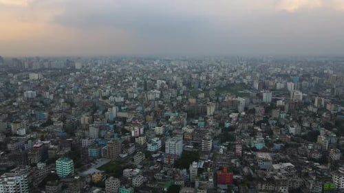 Vast panoramic aerial view of an urban city, establishing drone descending shot