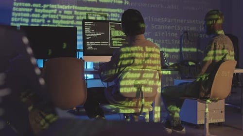 Two Programmers Working in Office at Night