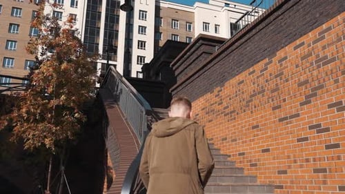 Man Walking Up Stairs in Urban Setting
