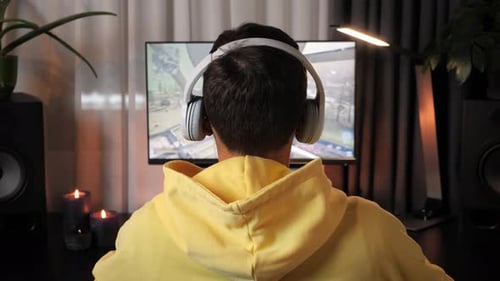 Adult Playing Video Game with Headphones On