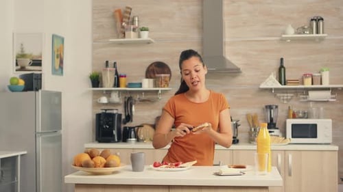 Woman Prepares Snack and Dances in Kitchen