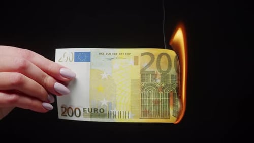 Euro Bill Burns in a Hand