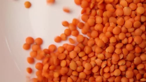 Orange Lentils Being Poured into a Bowl