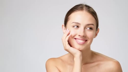 Beautiful Woman Smiling with Hand on Face