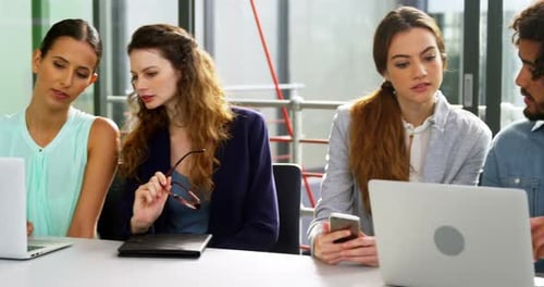 Young Adults Teamwork With Laptops in Office
