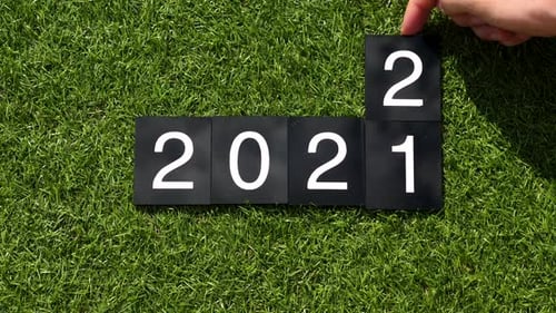Hand Changes Number Tiles to 2022 on Grass
