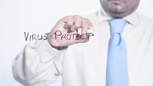 Man Writes Virus Protection on a Clear Surface