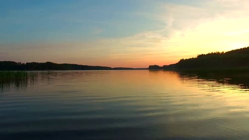Calm sunset over the lake in the summer
