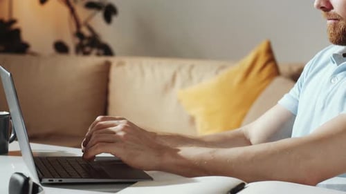 Man Working on Laptop at Home Office Desk