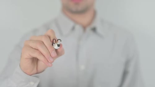 Man writes Accredited on Clear Surface with Marker