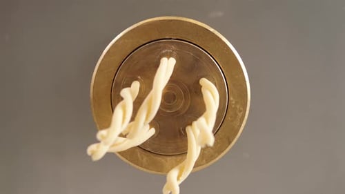 Pasta Dough Extruding from Pasta Maker Close Up
