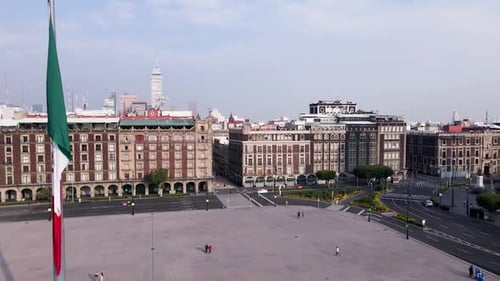 Aerial view of a drone with a mexican flag in the downtown of Mexico City in the morning