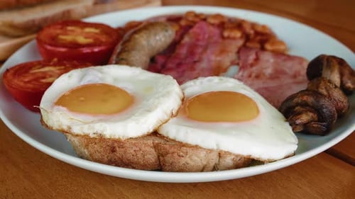 English Breakfast Close Up Fried Eggs Sausages Bacon Tomatoes Tomato Beans Toasts in White Plate on