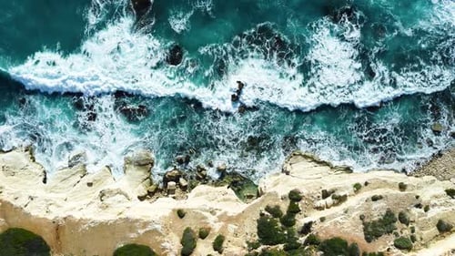 Rocky Coastline Cliffside with Blue Mediterranean Sea Ocean Water at Sunny Day Cyprus