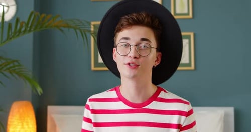 Young trendy man vlogger look at camera talk make recording live video stream conference video call