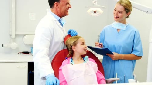 Young Girl at the Dentist With Doctor and Assistant