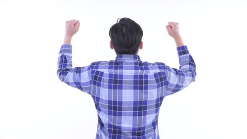 Rear View of Happy Young Asian Hipster Man with Fists Raised