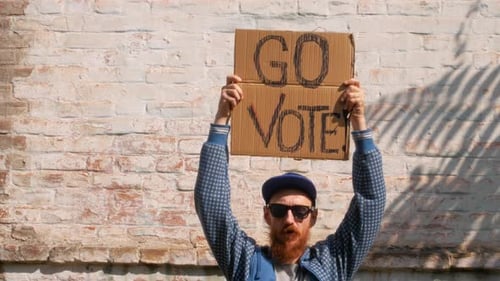 Man shows cardboard Go Vote sign Make the political choice Use your voice Presidential elections 4K