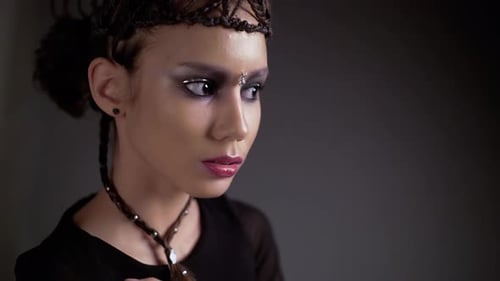 Young Woman with Dramatic Makeup and Braided Hairstyle