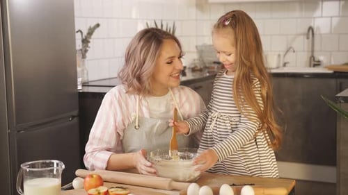 Mother and Child Baking Together in Kitchen