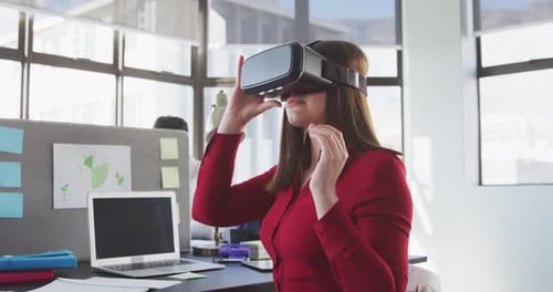 Businesswoman using VR headset in modern office