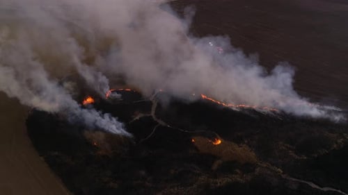 Aerial View of a Wildfire in a Rural Field