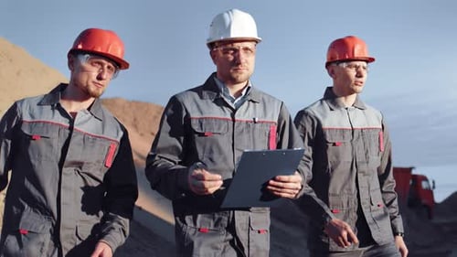 Focused Skilled Group of Industrial Male Worker Walking on Construction Site at Sunset Medium Shot