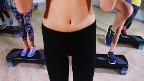 Women Exercising With Dumbbells in Gym Setting