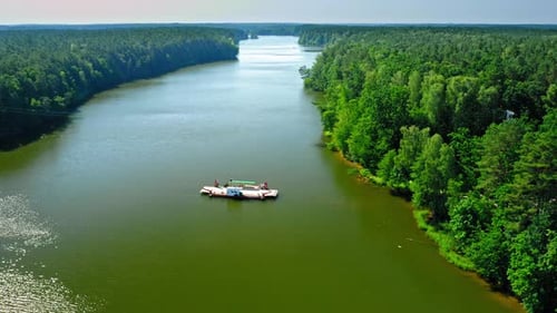 Aerial view of ferry boat on river transporting a car