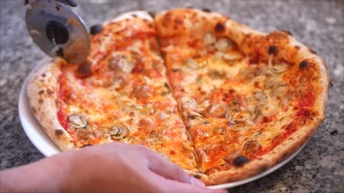 Cutting Fresh Pizza With Pizza Cutter