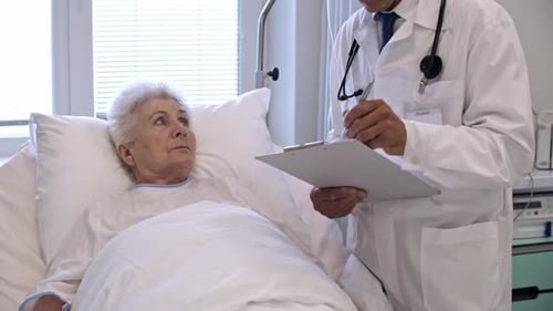Doctor Visiting Elderly Patient in Hospital