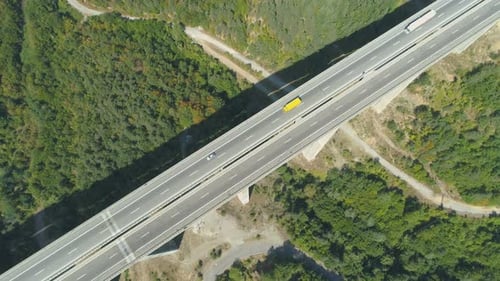 Top View of Highway Bridge with Yellow and White Truck Driving Along