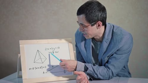 Man Explains Math Diagram on Whiteboard