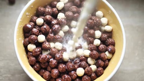 Milk Being Poured Into Bowl of Cereal