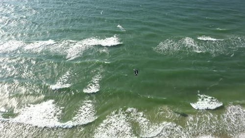 AERIAL: Drone view of the Ocean and People Engaged in Extreme Sports, Kitesurfing