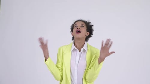 Woman Catches Something Falling and Smiles