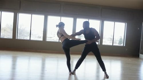 Man and Woman Dancing in Bright Studio