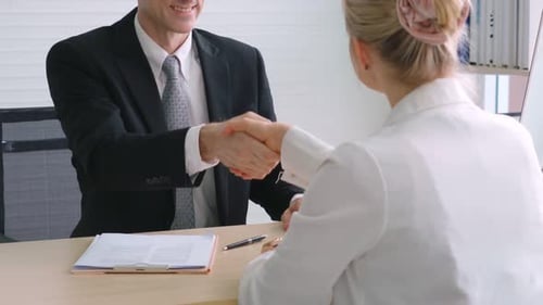 Business Handshake in Bright Office Setting