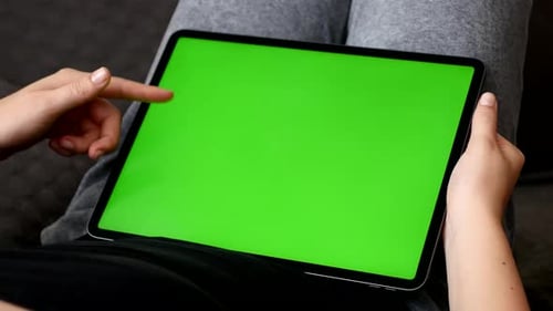 Big green screen tablet in female hands 4K footage