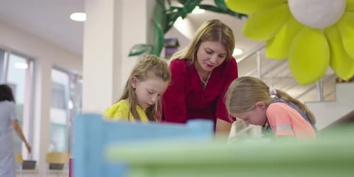 Creative Kids During an Art Class in a Daycare Center or Elementary School Classroom Drawing with