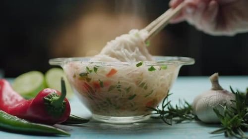 Steaming Noodle Soup with Vegetables Lifted by Chopsticks