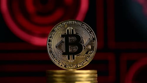 Rotating Bitcoin on Stack of Gold Coins