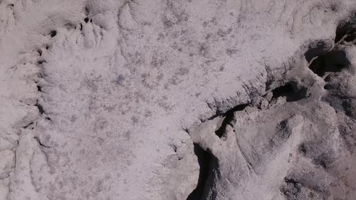 Aerial view looking down at eroded desert terrain