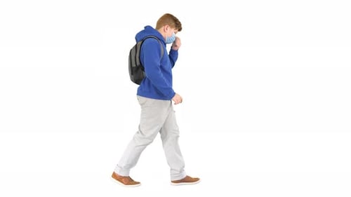 Red-Haired Teen Walks with Face Mask and Backpack