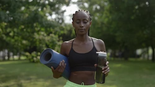 Active Woman with Yoga Mat in Green Park