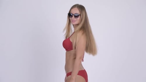 Woman in Bikini Removes Sunglasses and Waves